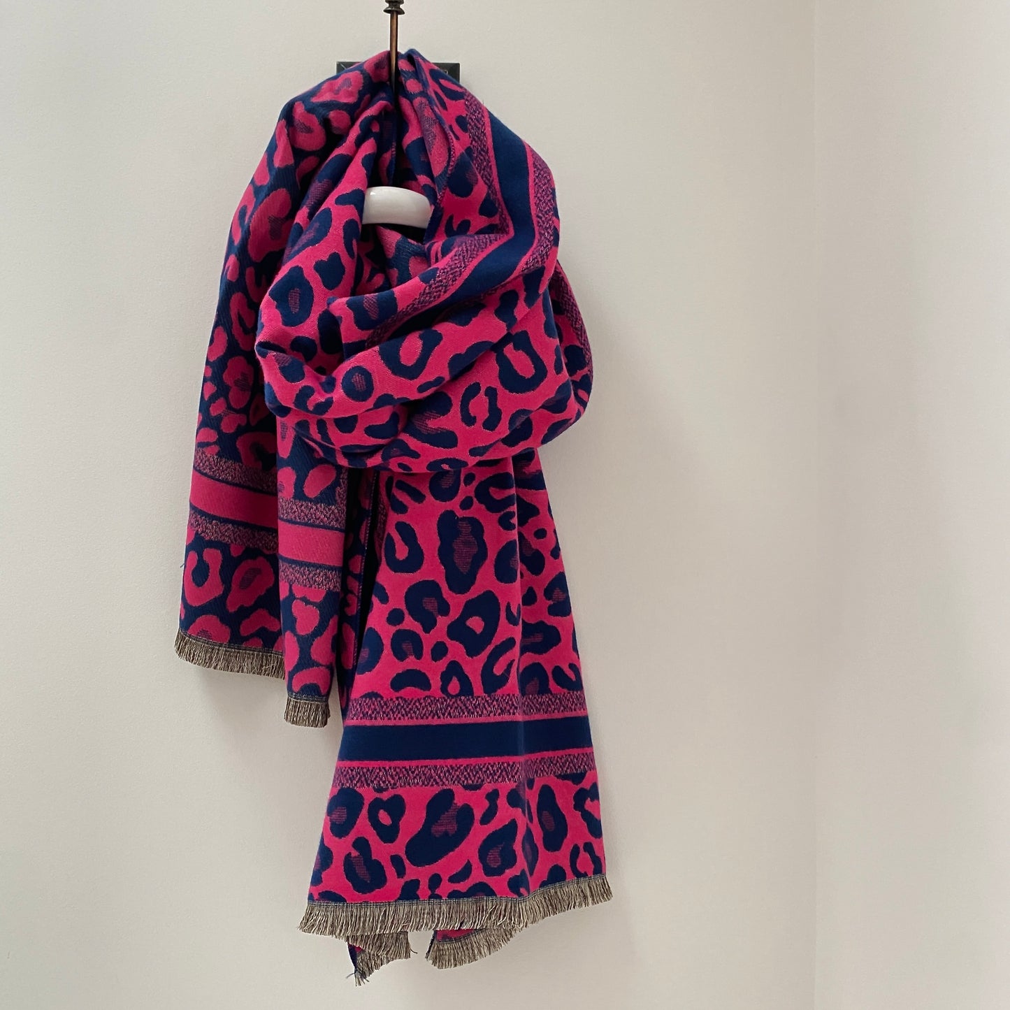 PINK LEOPARD PRINT PATTERN WOMENS SCARF      Navy and Pink Leopard print scarf     Super soft fabric     Border print detail      Frayed ends     Measures 70" long x 27" wide     80% Viscose 20% Wool     Available in Black and Green